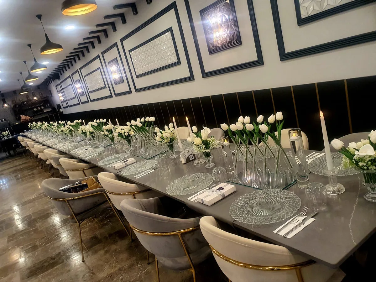 Long event table styled with Glassy X Vases and Crystal Chargers